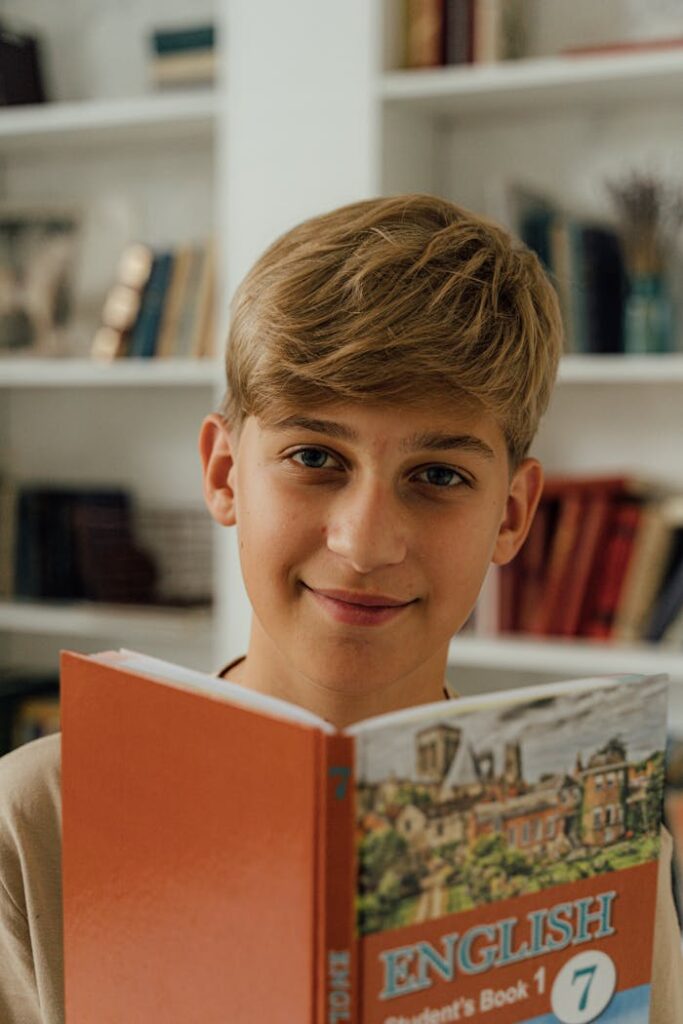 Boy with Blond Hair Holding an English Book